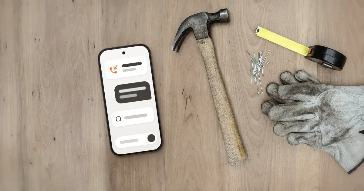 A phone on a job-site workbench showing a missed call and a short text reply
